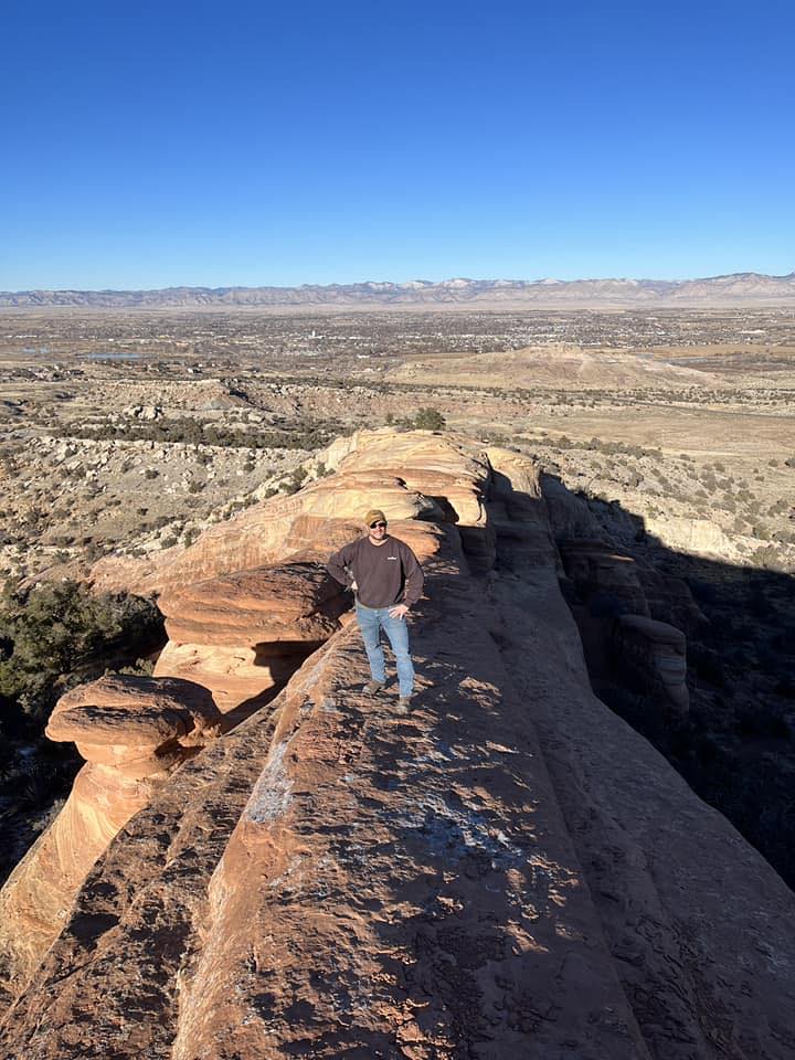 Man on mountain with blue sky